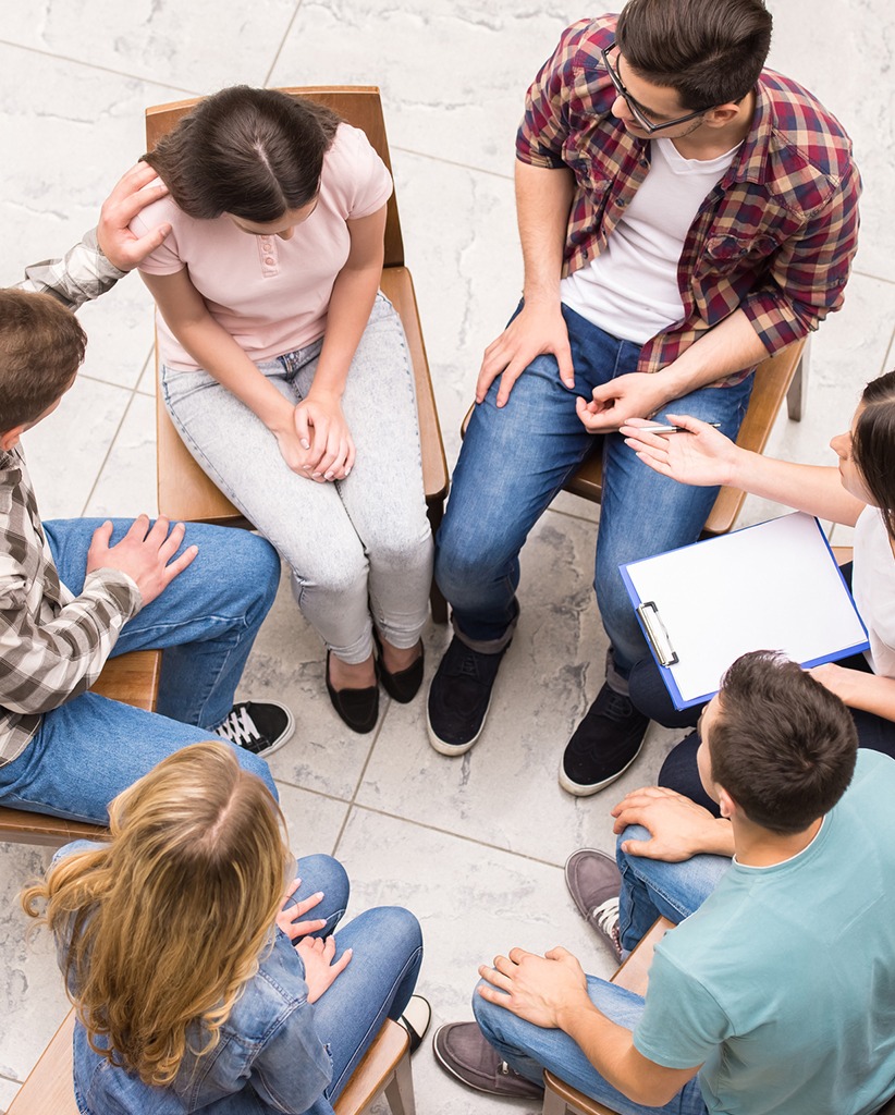 Top view of a group therapy session focusing on mental wellness, exploring Aetna mental health benefits.
